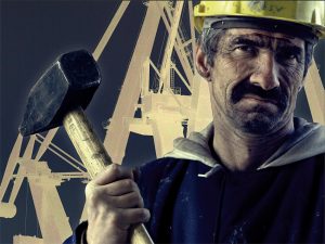 Ein Poster von einem Arbeiter mit rußigem Gesicht und gelbem Helm. Er hält einen Hammer hoch.